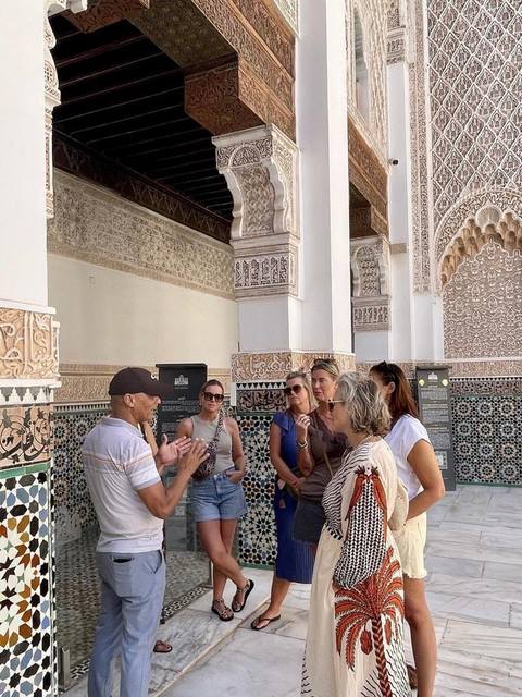 Adil explaining a monument to a small group
