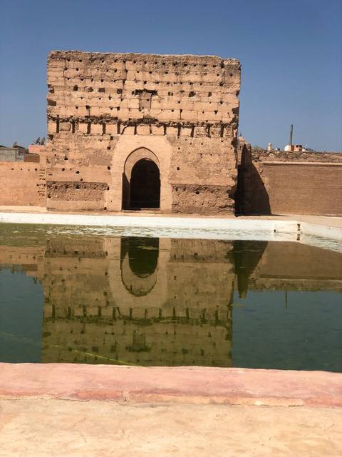 The ruins of El Badi Palace reflected in its pool