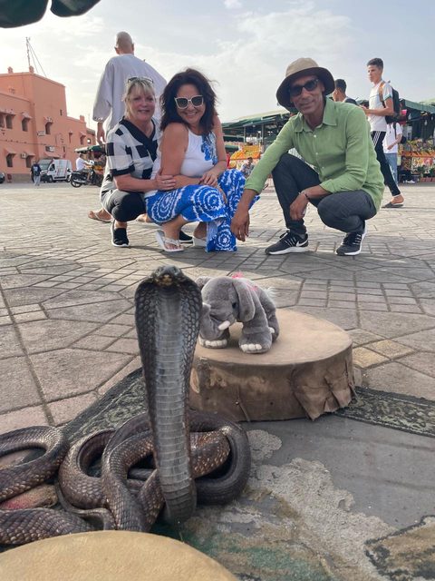 Adil and two guests beside the snake charmers on Jemaa el-Fna