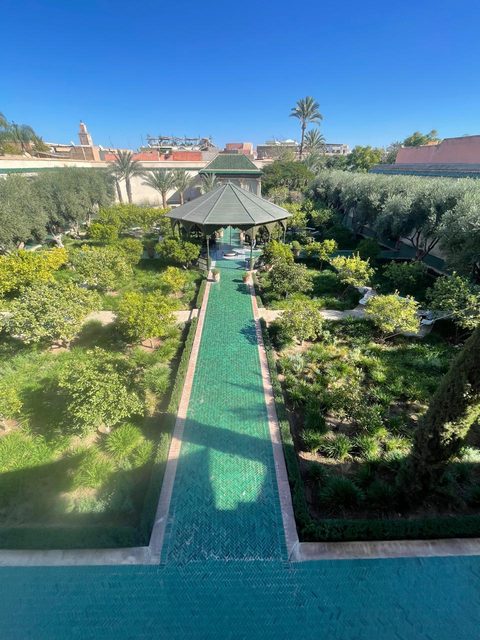 The green zellige canal and pavilion of a medina garden